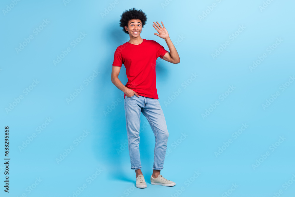 Full size body photo of friendly hipster guy funny chevelure hand waving greetings welcome new colleagues isolated on blue color background