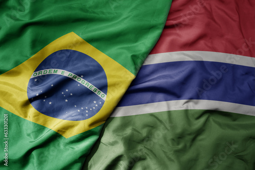 big waving realistic national colorful flag of brazil and national flag of gambia . photo