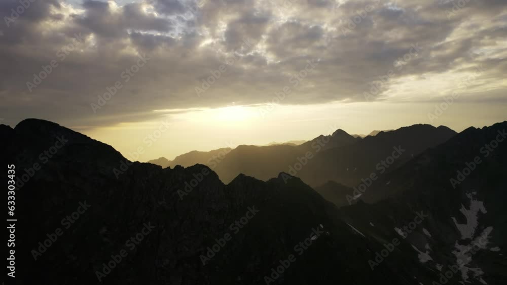 Movement in the mountainous landscape. Aerial shot of the mountains. Aerial Flight Footage Over Peaks Epic Panorama Nature Top Peak. Beautiful sunrise over wild forest mountains in summer morning. Movement in the mountainous landscape. Aerial shot of the mountains. Aerial Flight Footage Over Peaks Epic Panorama Nature Top Peak. Beautiful sunrise over wild forest mountains in summer morning.