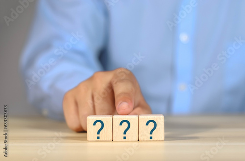 Question mark, Confused, Thinking, Brainstorming or Decision, Problem Solving, Finding Answer, Question. Marked words in wooden blocks on table top.	
