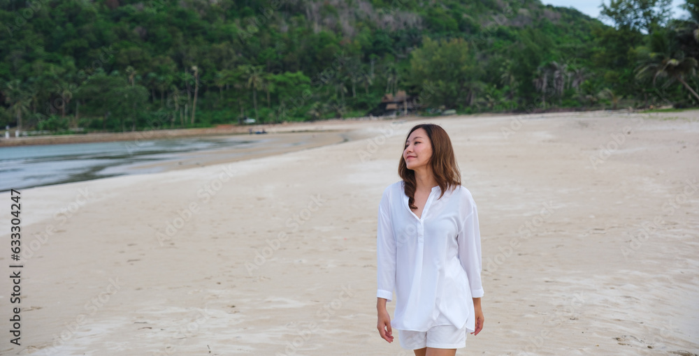 Portrait image of a beautiful young asian woman while strolling on the beach Portrait image of a beautiful young asian woman while strolling on the beach