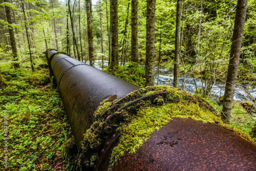 long old rusty pipeline for water supply with green moss in the nature long old rusty pipeline for water supply with green moss in the nature