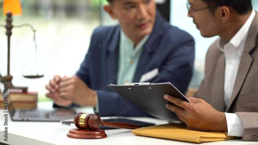 Business people and lawyers discussing contract papers sitting in the table at office in the morning. concepts of law, advice, legal services. Business people and lawyers discussing contract papers sitting in the table at office in the morning. concepts of law, advice, legal services.