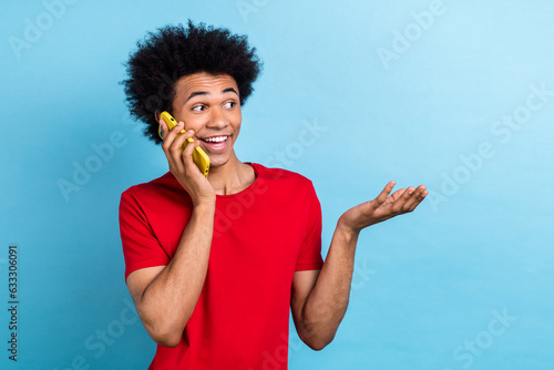 Photo of funky positive person toothy smile speak communicate telephone isolated on blue color background