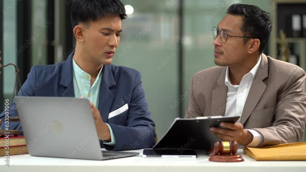 Middle age partner lawyers attorneys shaking hands after discussing a contract agreement done. Middle age partner lawyers attorneys shaking hands after discussing a contract agreement done.
