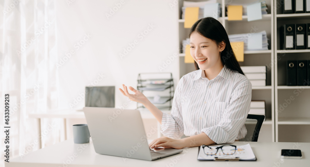 Asian business woman are delighted and happy with the work they do on their tablet, laptop and taking notes at the office.. Asian business woman are delighted and happy with the work they do on their tablet, laptop and taking notes at the office..
