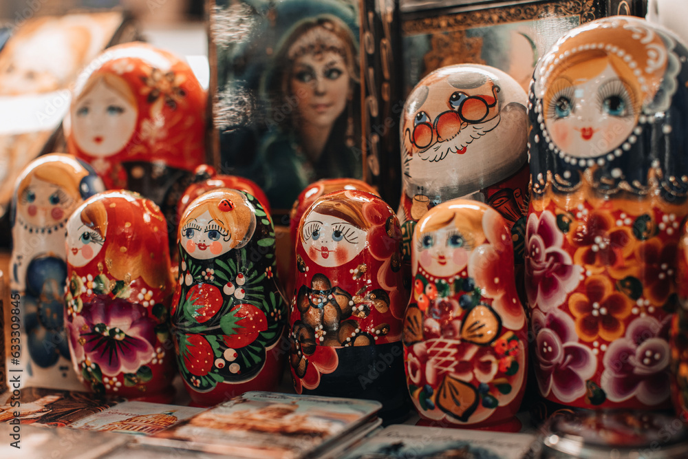 Hand painted famous Russia wooden doll Matryoshka. Females cartoon faces with red lipstick and rosy cheeks. Traditional souvenir