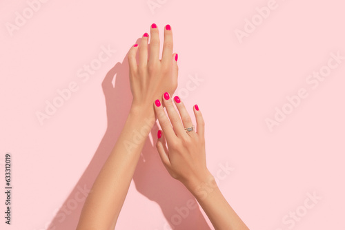 Fototapete Womans hands with pink nail design