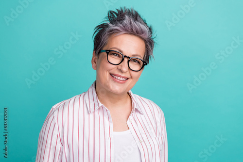 Portrait of attractive confident middle age woman smiling cheerful wear striped shirt eyeglasses isolated teal color background