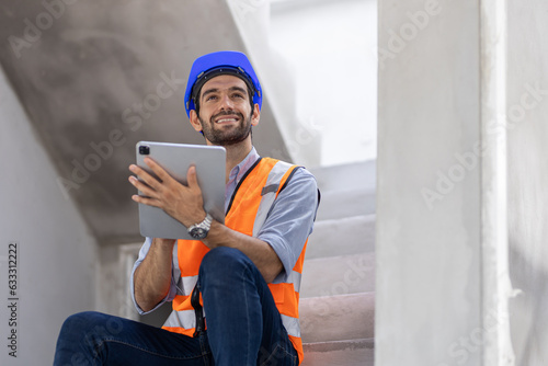 Portrait of handsome successful architect standing with arms crossed in building in construction process.