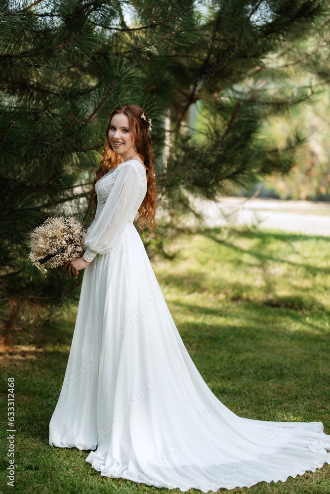 red-haired girl bride with a wedding bouquet