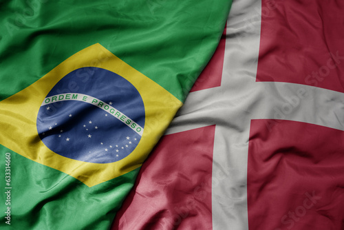 big waving realistic national colorful flag of brazil and national flag of denmark .