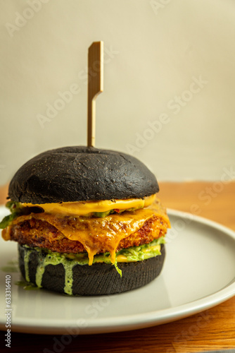 juicy black bun burger on a grey background