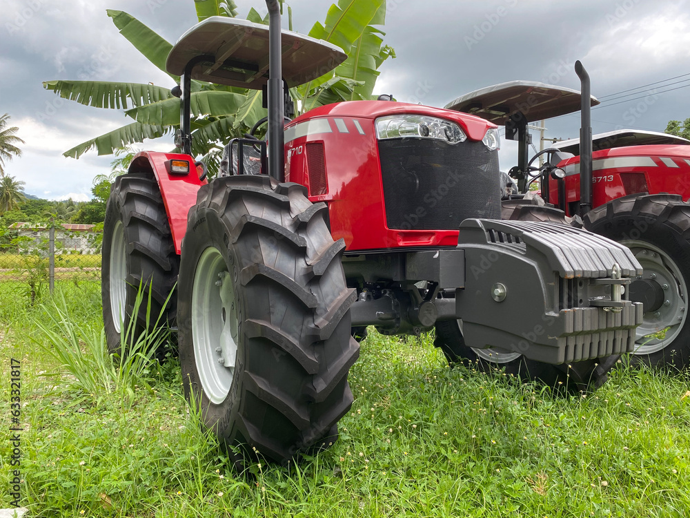Newly issued Farm tractor in a university parking facility Newly issued Farm tractor in a university parking facility
