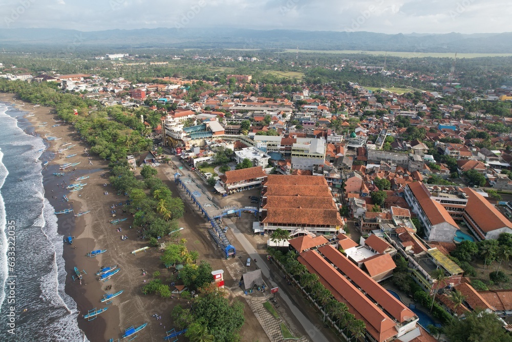 Fototapeta premium urban aerial view on the beach. houses with terracotta roof tiles. beach views in Indonesia. Pangandaran beach. 