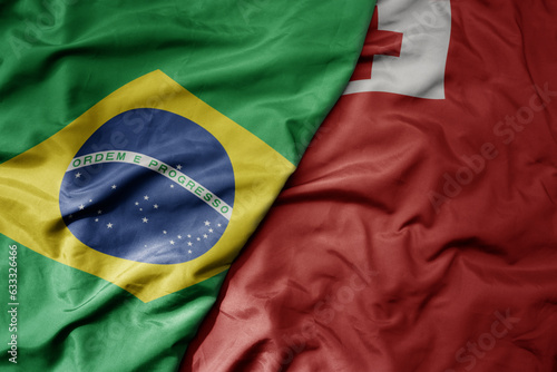 big waving realistic national colorful flag of brazil and national flag of Tonga .