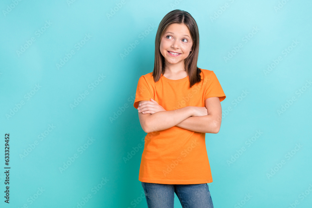 Portrait of good mood nice schoolgirl dressed orange t-shirt arms crossed look empty space promo isolated on turquoise color background Portrait of good mood nice schoolgirl dressed orange t-shirt arms crossed look empty space promo isolated on turquoise color background