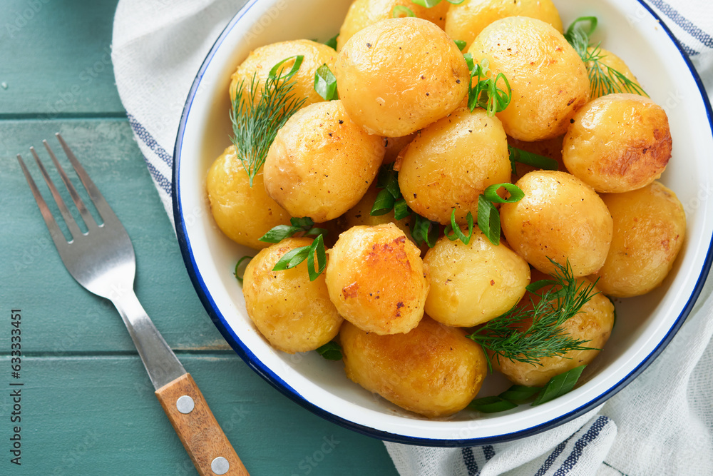 Fresh boiled new or young potatoes with butter, fresh dill and onions in white bowl on old rustic wooden background. Tasty new boiled potatoes. Top view. Fresh boiled new or young potatoes with butter, fresh dill and onions in white bowl on old rustic wooden background. Tasty new boiled potatoes. Top view.