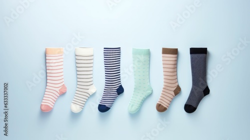 five different men's socks in a row on a pastel blue background, concept. Copy space. Generative AI