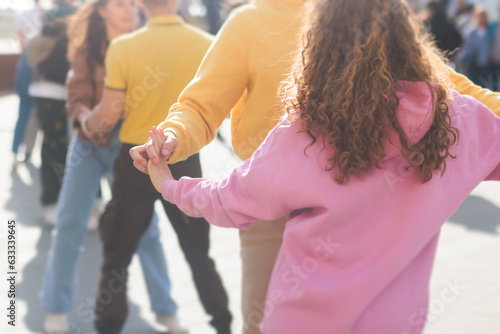 Couples dancing traditional latin argentinian dance milonga outdoor in the city streets, tango salsa bachata kizomba lesson, outdoors dance school class festival in a summer sunny day photo