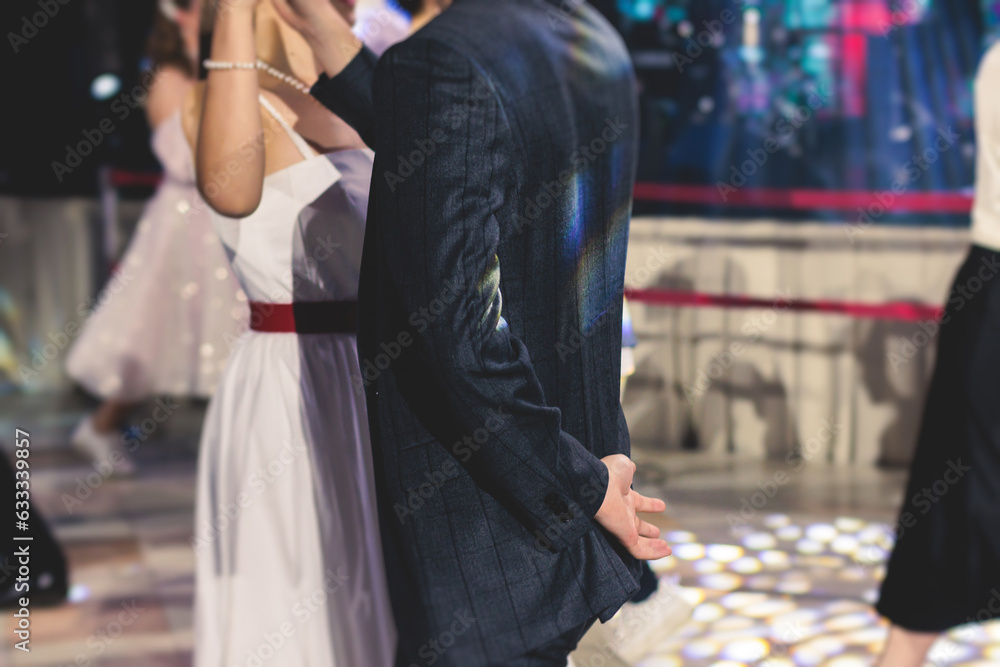 Obraz premium High school graduates dancing waltz and classical ball dance in dresses and suits on school prom graduation, classical ballroom dancers dancing, waltz, couples quadrille and polonaise