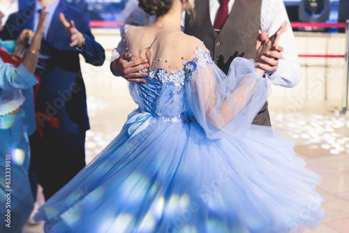 High school graduates dancing waltz and classical ball dance in dresses and suits on school prom graduation, classical ballroom dancers dancing, waltz, couples quadrille and polonaise photo