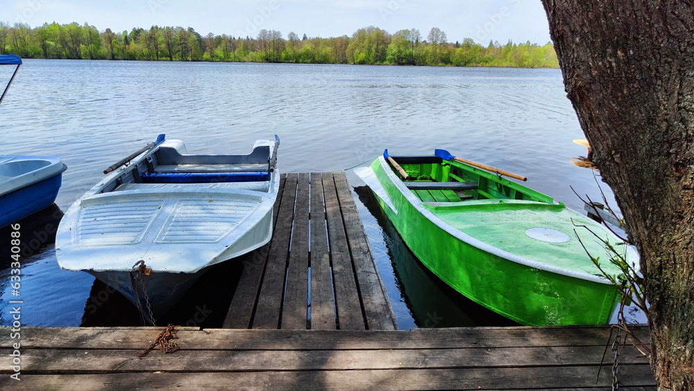 Obraz premium Old boats on water of river or lake in autumn, sprin, summer season. Landscape with water and boat