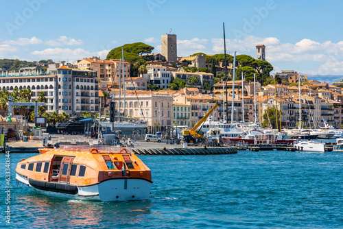Cannes seafront panorama with castle hill over historic old town Centre Ville quarter and yacht port at French Riviera of Mediterranean Sea in France