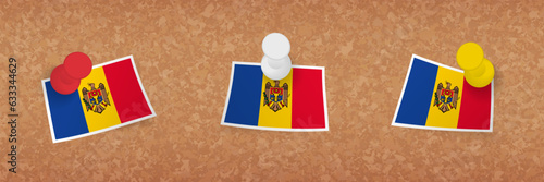 Moldova flag pinned in cork board, three versions of Moldova flag.