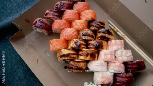 Wallpaper Mural Beautiful and juicy sushi set with red fish and shrimp poured with sauce, with rice, with chopsticks Japanese food Torontodigital.ca