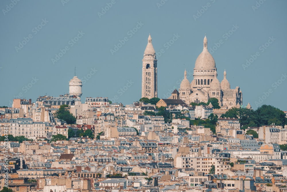 Fototapeta premium Aerial view of Paris cityscape from Sacre Coeur on a sunny summer day, with white architecture dominating.