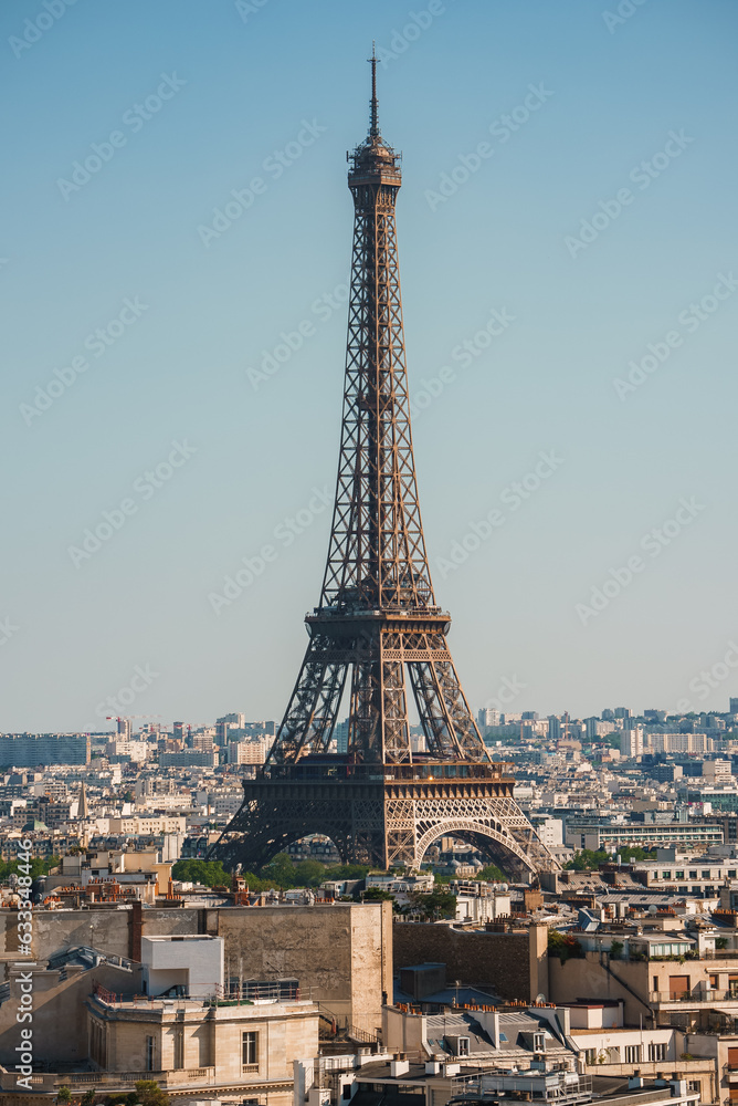 Daytime shot of the Eiffel Tower under a clear blue sky in Paris, France.
