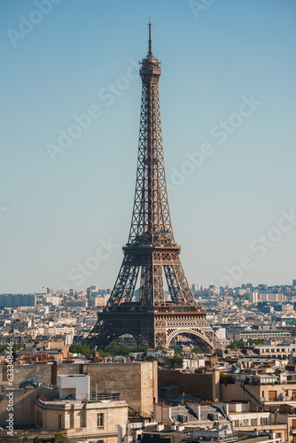 Daytime shot of the Eiffel Tower under a clear blue sky in Paris, France. © Aerial Film Studio