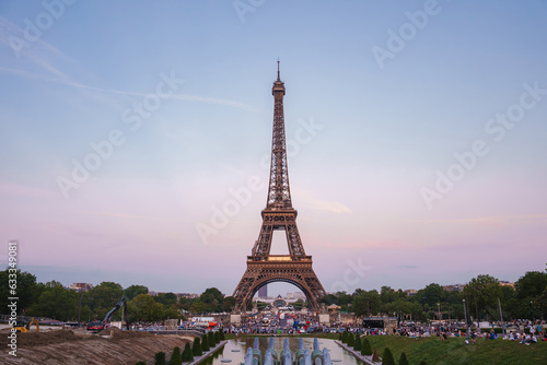 Eiffel Tower at dusk with a blue-hued Renaissance fountain in the foreground and a pink sky backdrop. © Aerial Film Studio