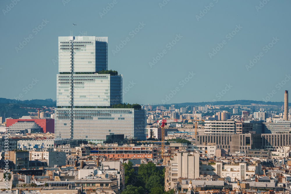 High angle view of a cityscape under a clear blue sky on a sunny summer day. Aerial Paris view.