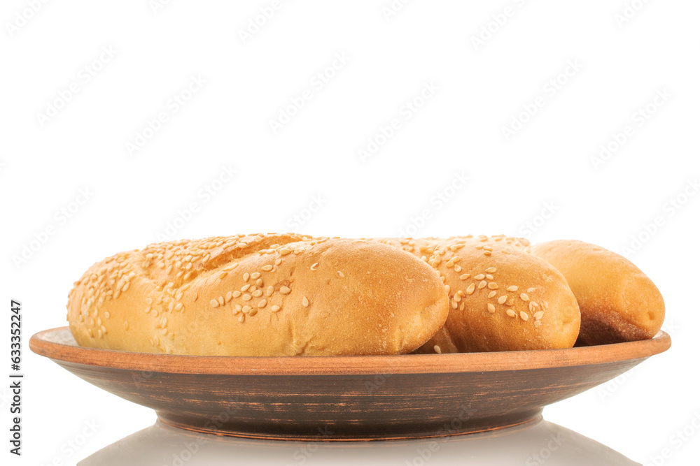 Three fragrant rolls on a clay plate, close-up, isolated on white. Three fragrant rolls on a clay plate, close-up, isolated on white.