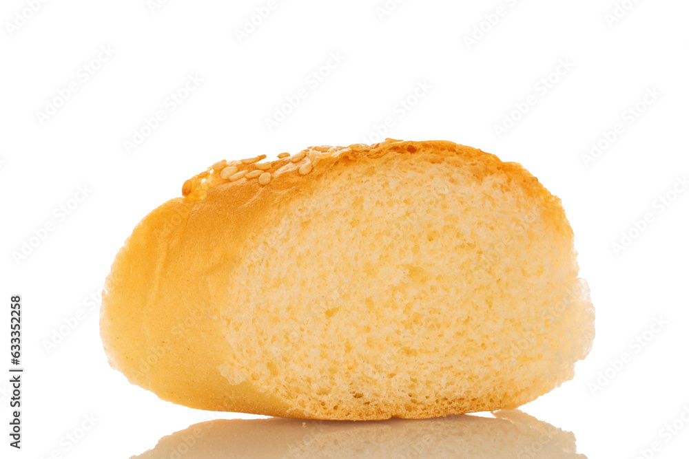 One slice of fragrant bun sprinkled with sesame seeds, close-up, isolated on white.
