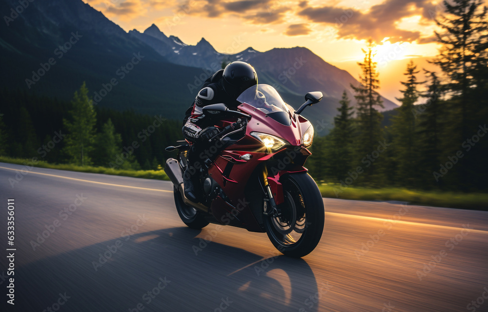 biker riding a motorcycle through mountain road 