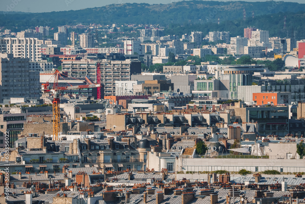 Aerial view of Paris, France featuring the Eiffel Tower under a sunny noon sky.