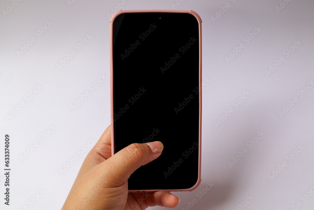 Hand holding a mobile phone on white background Hand holding a mobile phone on white background