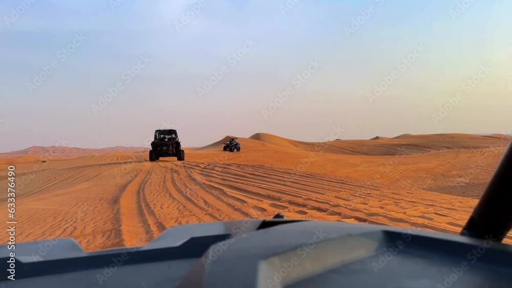 Riding buggies in the desert during sunset Riding buggies in the desert during sunset