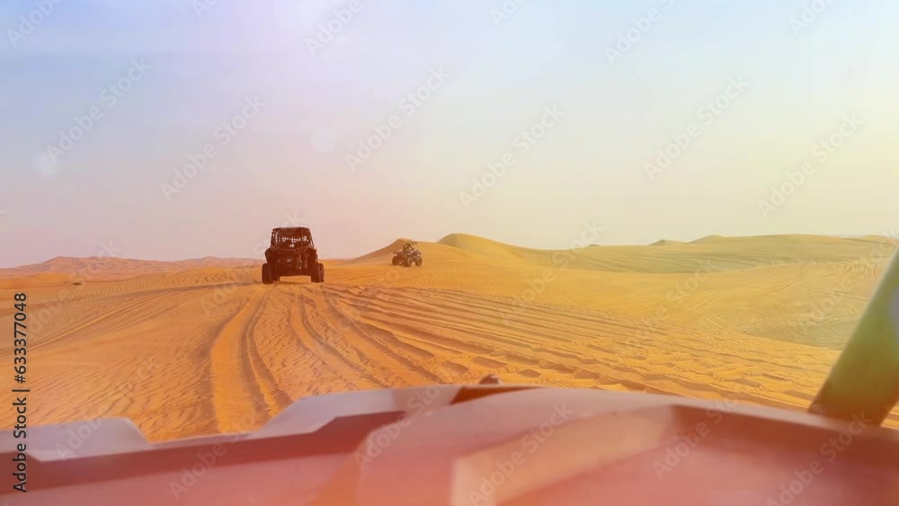 Riding buggies in the desert during sunset Riding buggies in the desert during sunset