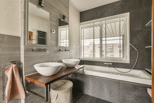 a bathroom with a sink  mirror and towel hanging on the wall next to the bathtub in the corner