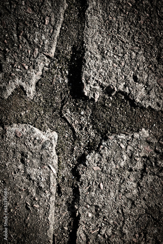 A cross carved or crushed into the asphalt