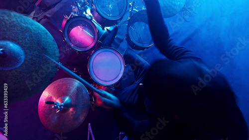 Canvas Print A drummer plays on a dark stage in the fog and neon lights.