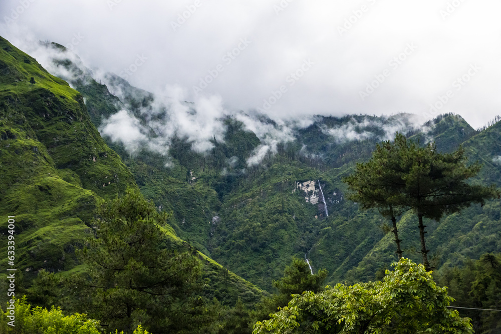 Breathtaking Green Landscape with Foggy Mountains and Waterfalls during Monsoon in Nepal