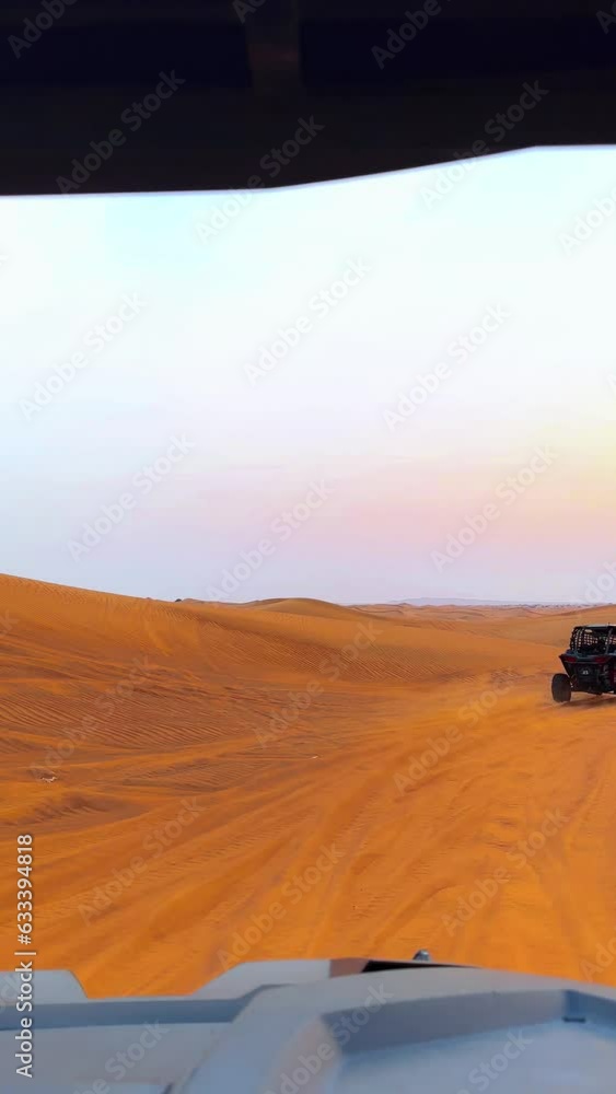 Riding buggies in the desert during sunset Riding buggies in the desert during sunset