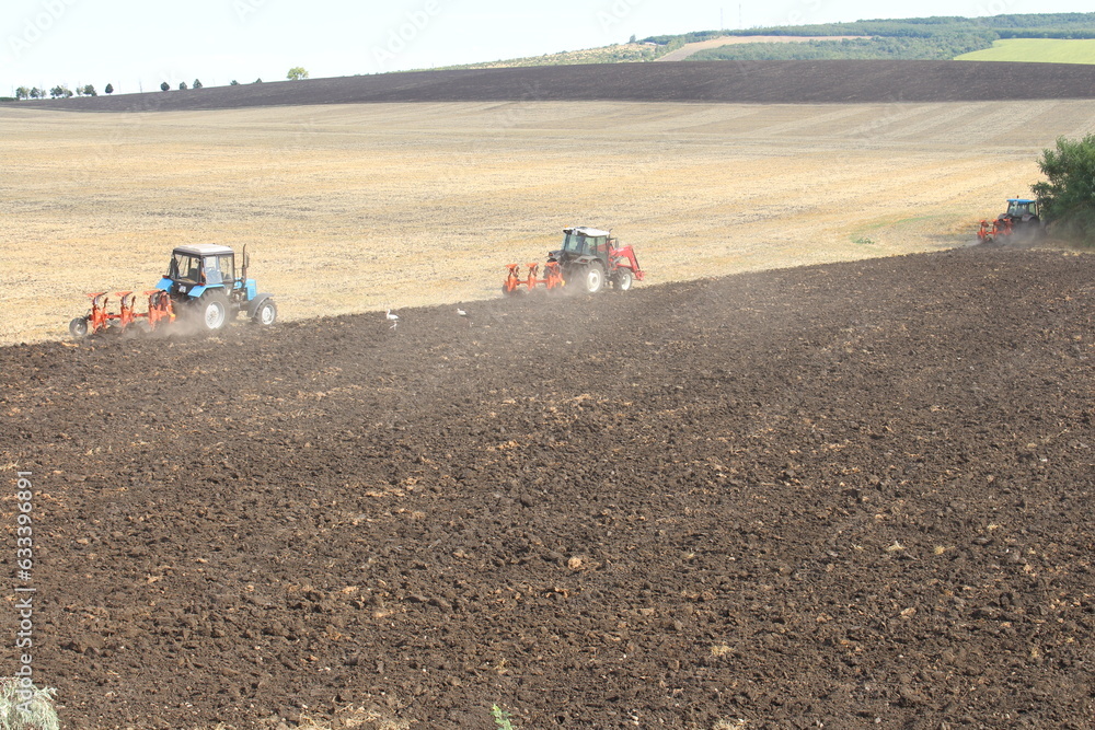 Fototapeta premium A tractor plowing a field