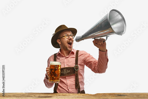 Canvas-taulu Portrait of man wearing traditional Bavarian or German oyfit shouting in vintage megaphone and inviting to beer party