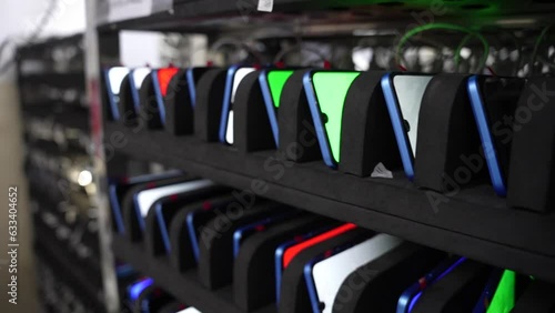 smartphones charging in a dock station in smartphone production assembly line